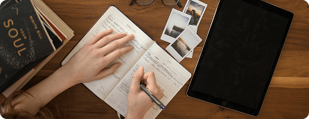 person writing in a journal